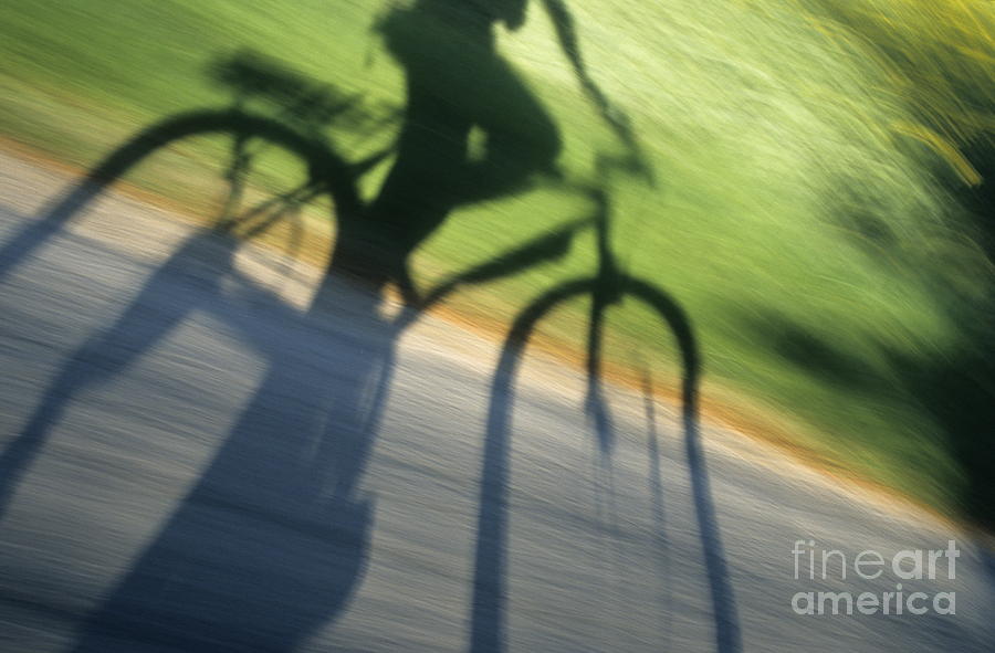 Speeding cyclists shadow on the road Photograph by Sami Sarkis