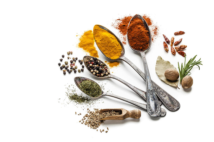 Spices and herbs in old spoons isolated on white background Photograph by Fcafotodigital