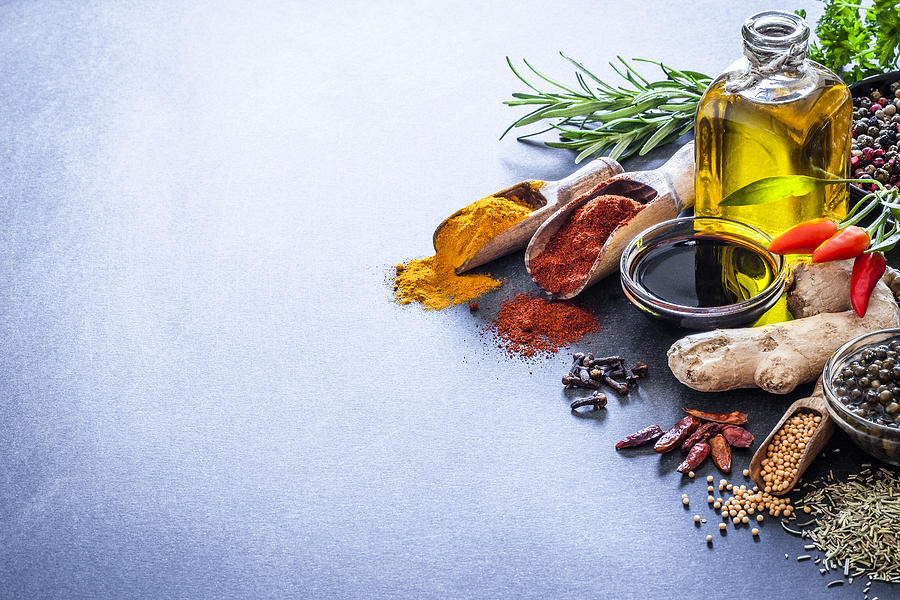 Spices and herbs on bluish kitchen table Photograph by Fcafotodigital