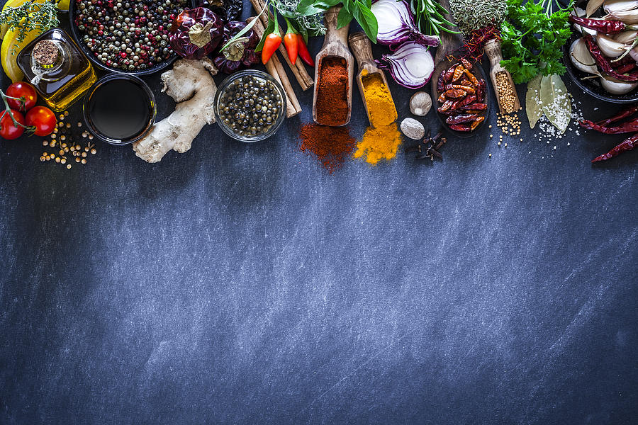 Spices and herbs on dark kitchen table Photograph by Fcafotodigital
