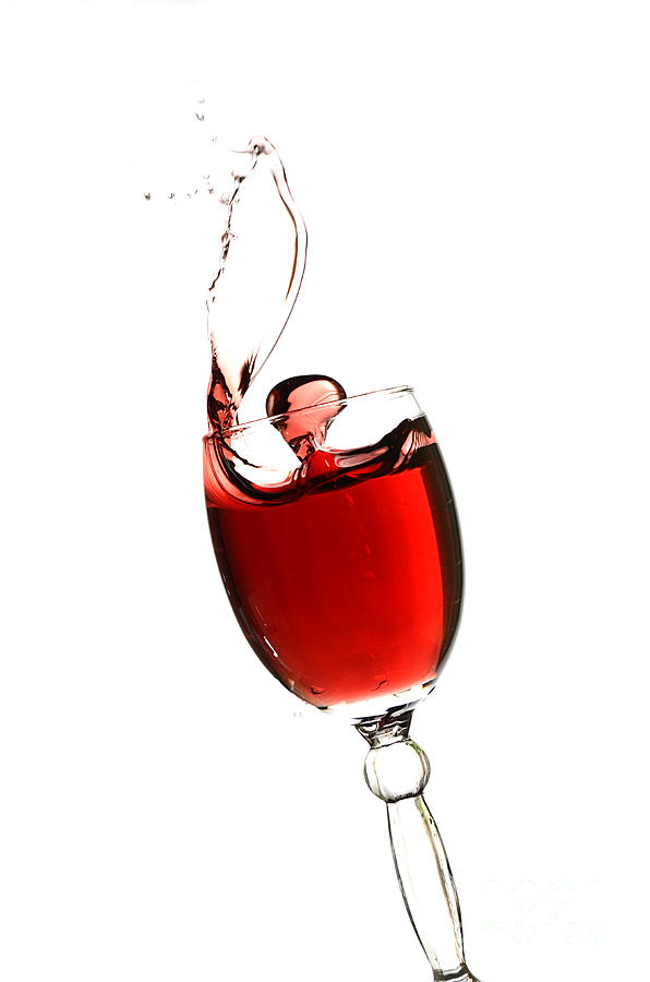 Wine Photograph - Splashing glass of red wine by Andreas Berheide