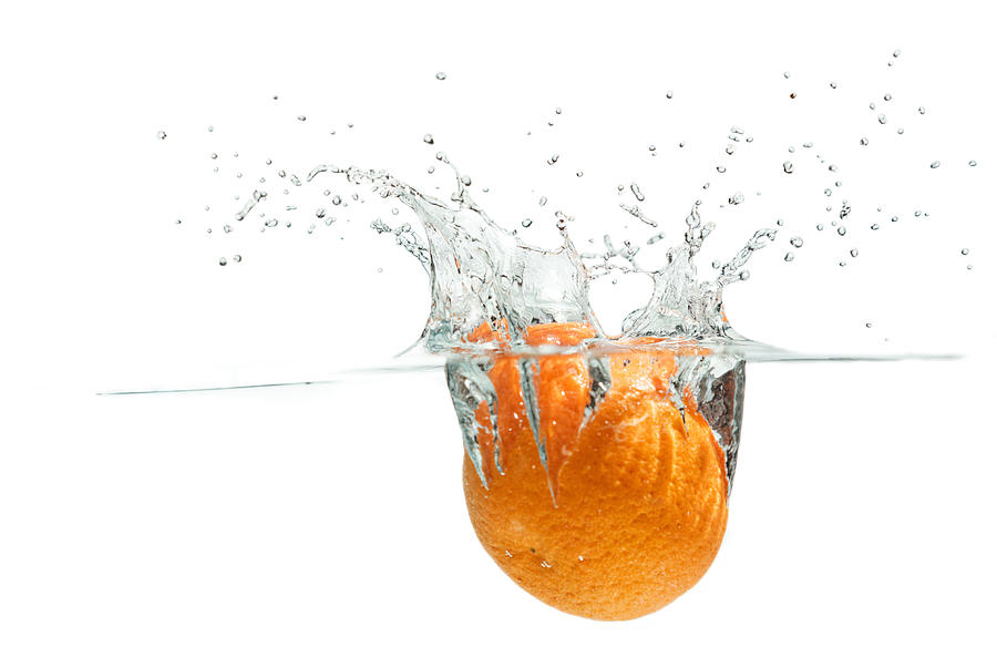 Splashing Orange Photograph by Peter Lakomy
