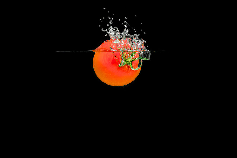 Splashing Tomato Photograph by Peter Lakomy