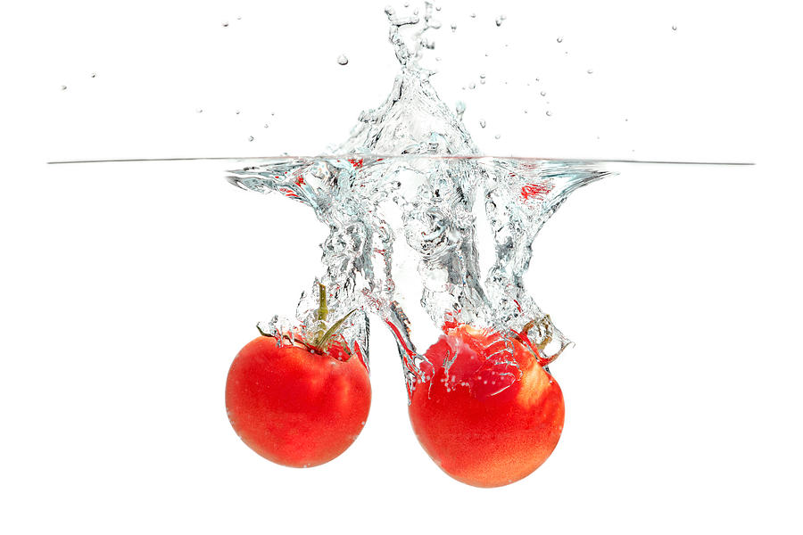 Splashing Tomatoes Photograph by Peter Lakomy