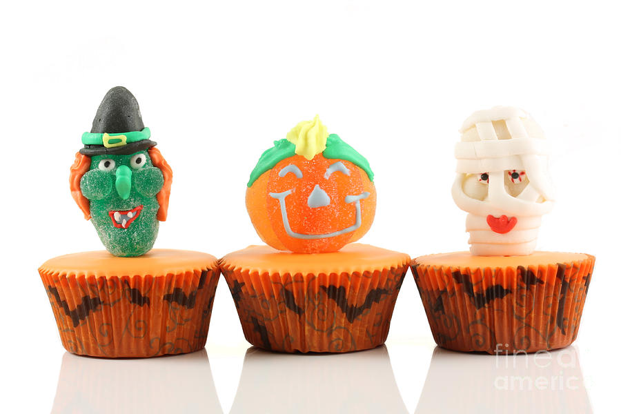 Spooks cup cakes on white background Photograph by Simon Bratt