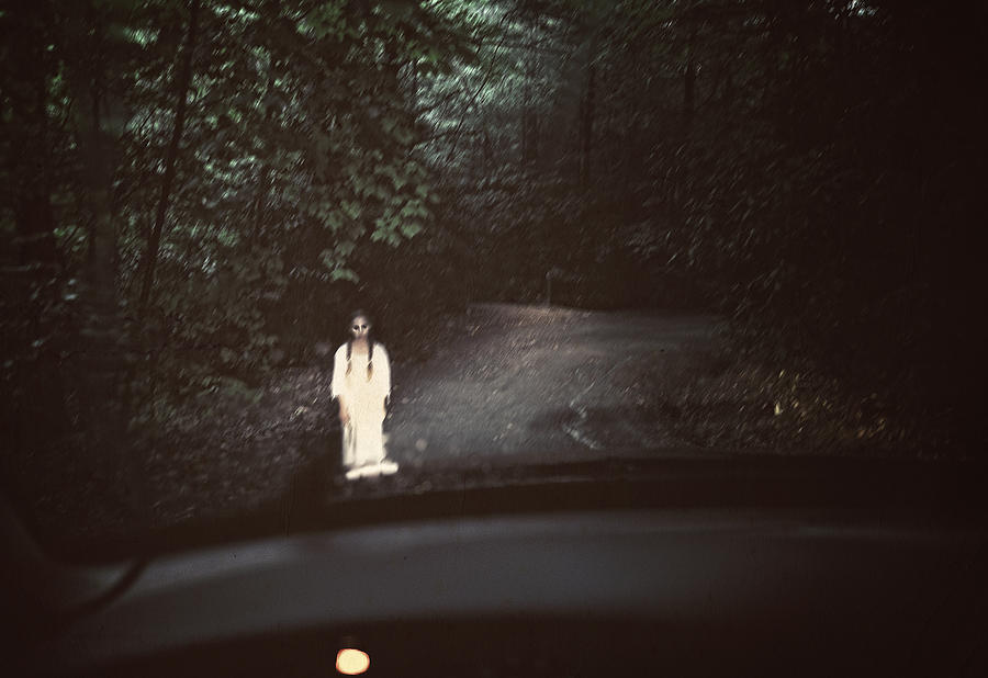 Spooky ghost in white standing in the middle of a dark road Photograph by EricVega