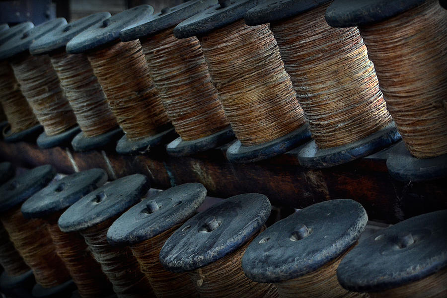 Spools in a Row Photograph by Nadalyn Larsen