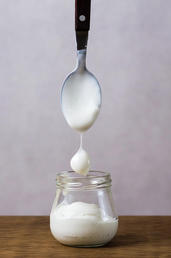 Spoon Above Yogurt Jar On Table Photograph by Mónica Durán / Eyeem