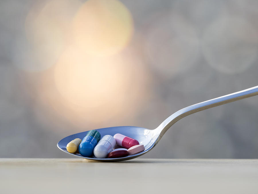 Spoon fills of medicines, tablets and pills Photograph by Jose A. Bernat Bacete