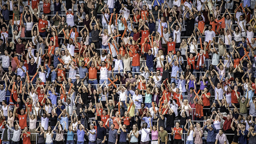 Sports fans in red jerseys cheering on stadium bleachers Photograph by Vm