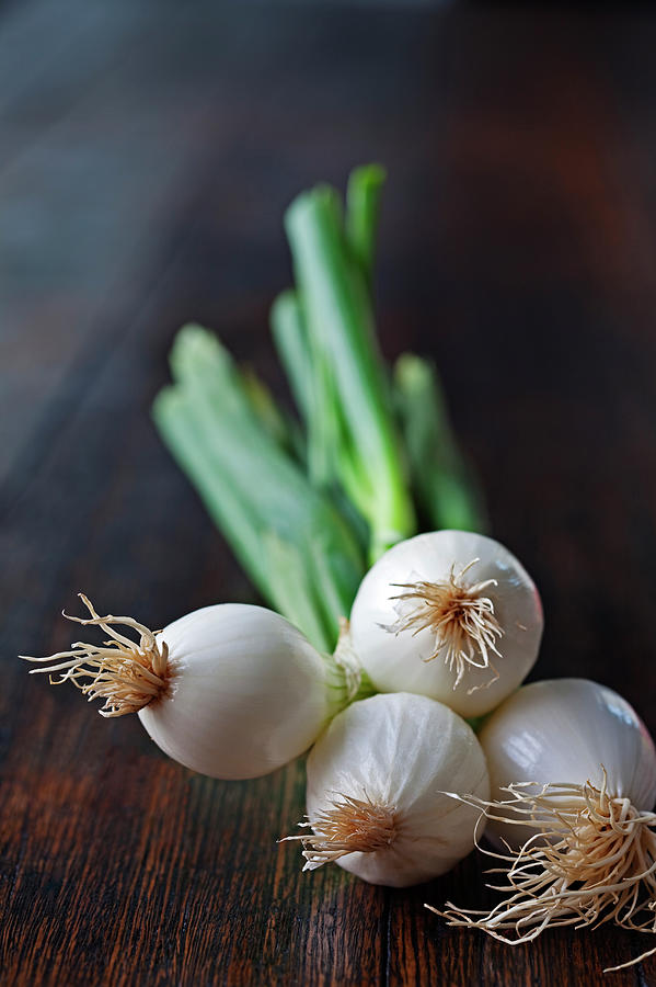Spring Onions On A Wooden Table Top Photograph by John W Banagan