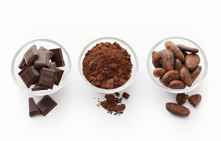 Squares of chocolate, cocoa powder and cocoa beans in glass dishes Photograph by Gross, Petr
