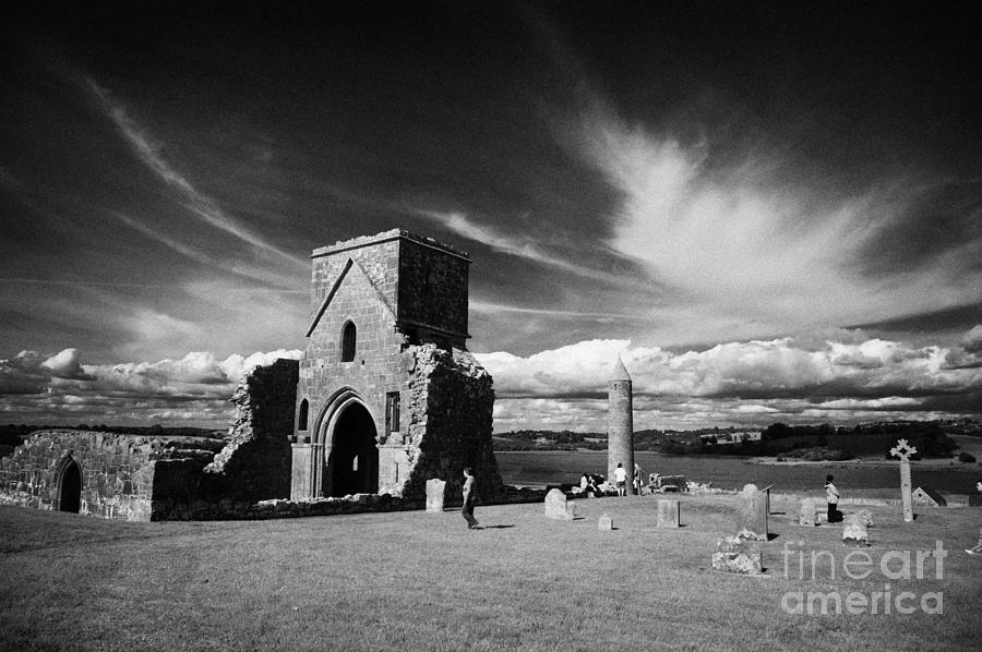 Summer Photograph - St Marys Augustinian Priory the round tower the high cross and graveyard on Devenish Island by Joe Fox