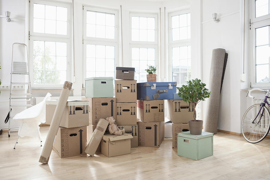 Stack of cardboard boxes in empty apartment Photograph by Westend61