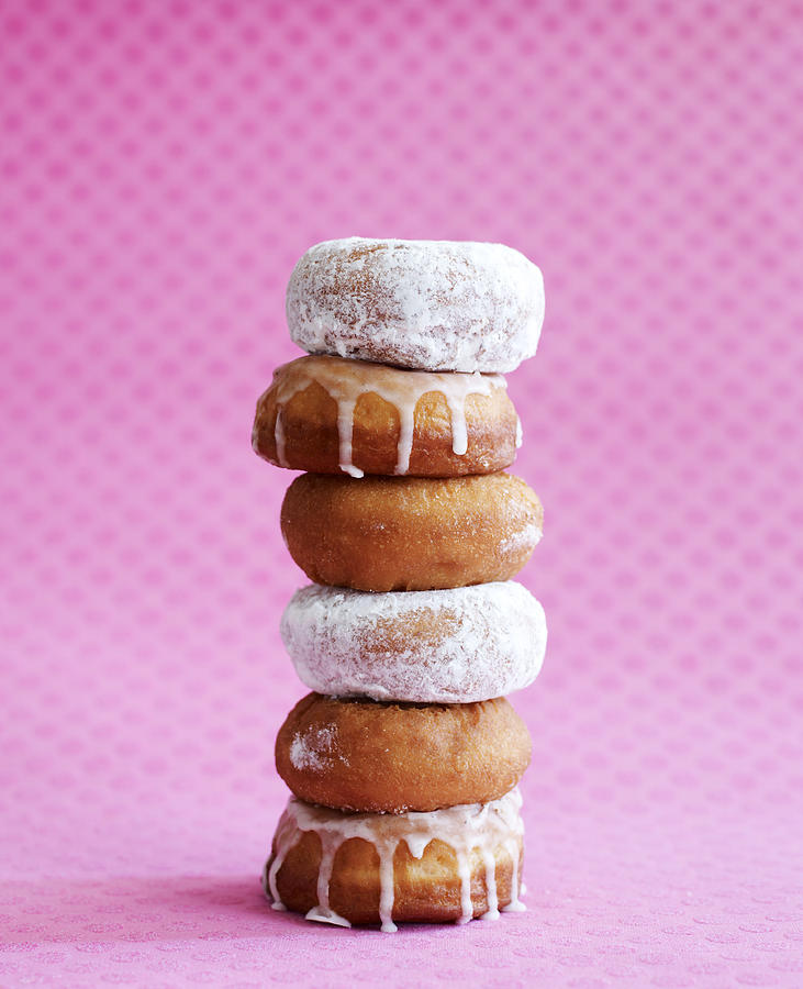 Stack of Donuts on Pink Background Photograph by Lauren Burke