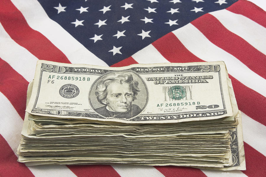 Stack of Money On American Flag  Photograph by Keith Webber Jr