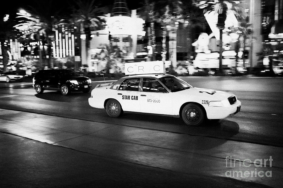 Las Vegas Photograph - star cab speeding down Las Vegas boulevard at night Nevada USA deliberate motion blur by Joe Fox