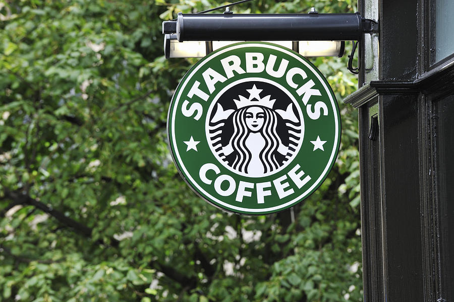Starbucks coffee sign hanging outside a shop Photograph by JohnFScott