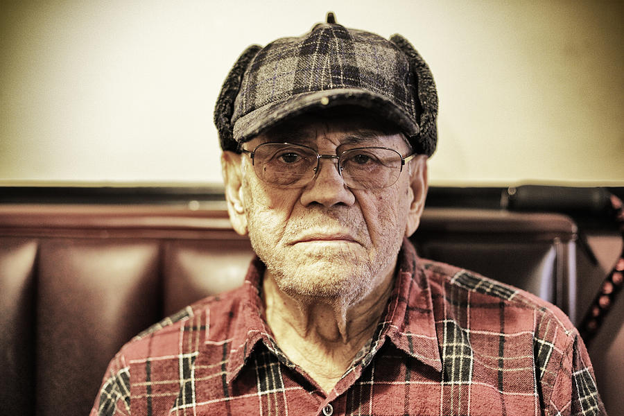 Staring Senior Man Wearing Plaid Hunter Cap Photograph by Willowpix