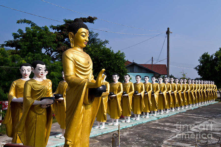 Buddha Photograph - Statue of Buddha and disciples are alms round by Tosporn Preede