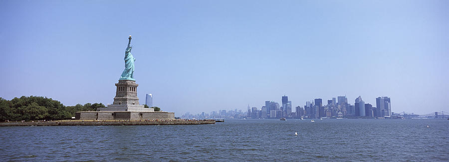 Architecture Photograph - Statue Of Liberty With Manhattan by Panoramic Images