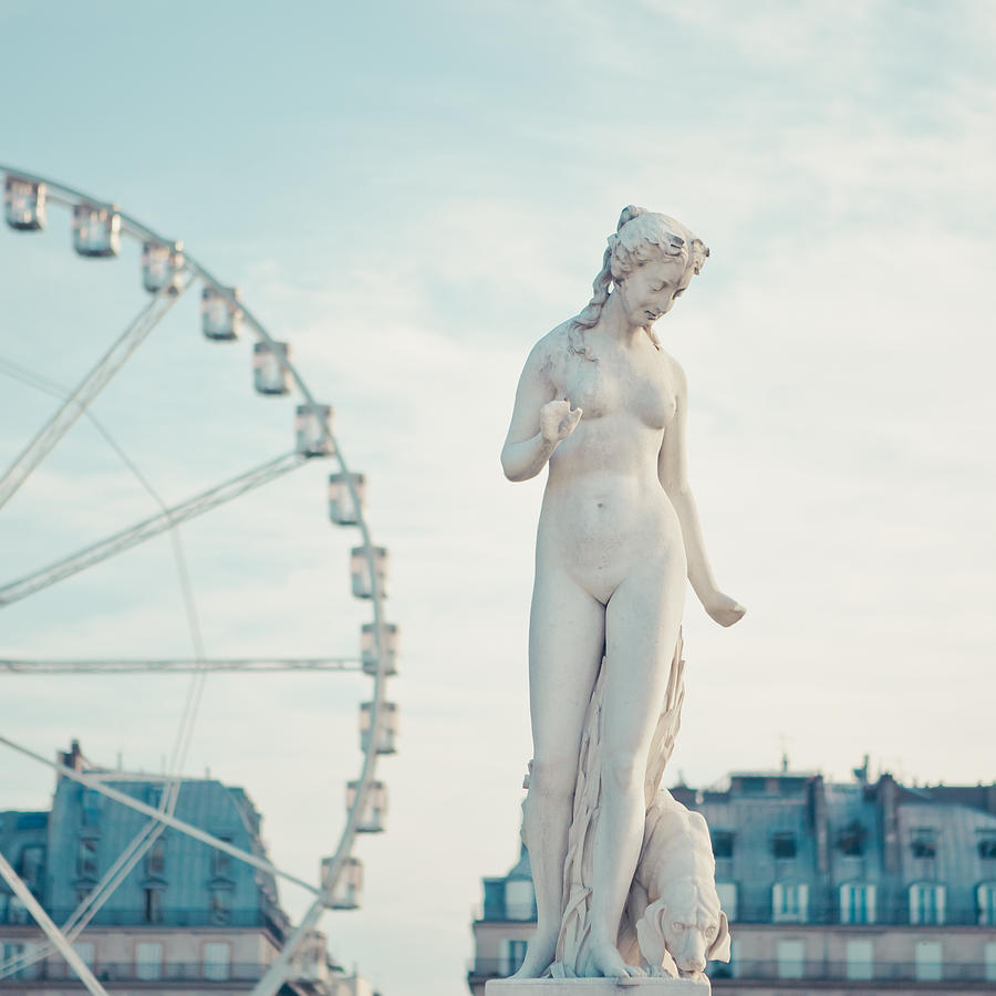 Statue of naked lady and carrousel in back Photograph by Cindy Prins