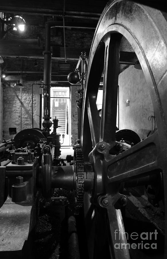 Black And White Photograph - Steam engine flywheel at Lockes distillery BW  by RicardMN Photography