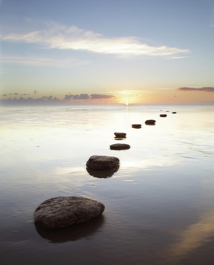 Stepping Stones Over Water At Sunrise Photograph by Peter Cade