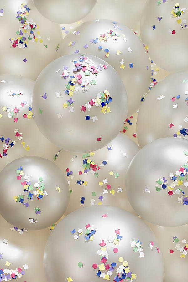 Still life of silver colored balloons and confetti for party decoration, backgrounds Photograph by The_burtons