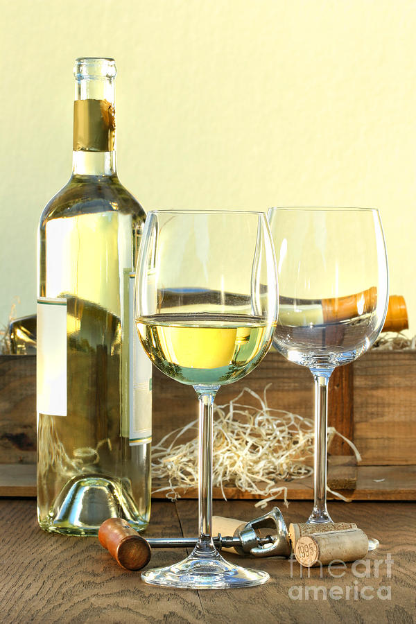 Still life of white wine bottle and glasses with crate Photograph by Sandra Cunningham