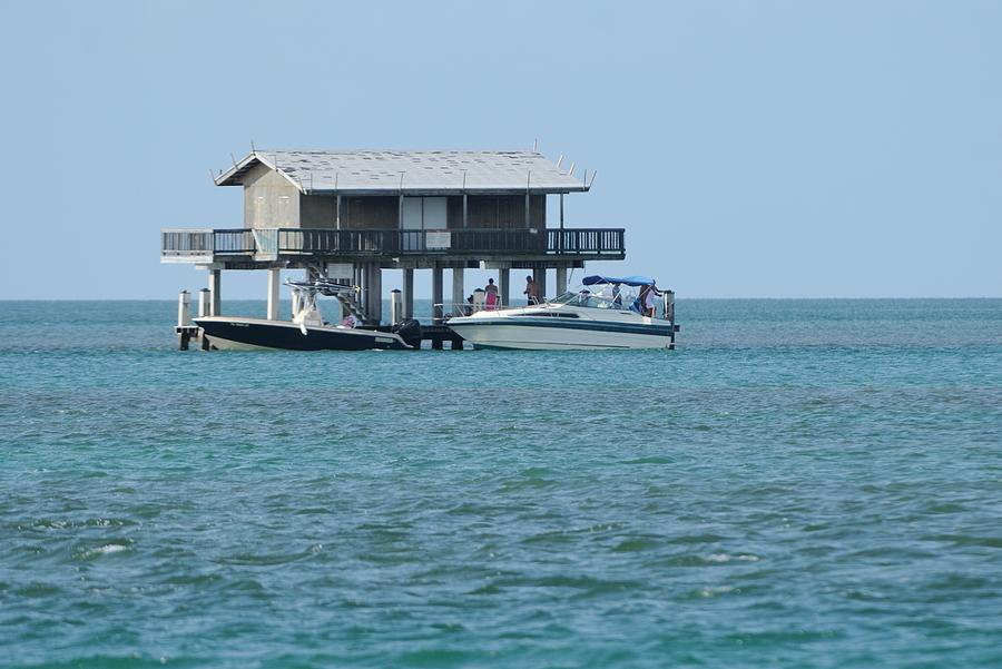 Stilt house with boats Photograph by Bradford Martin
