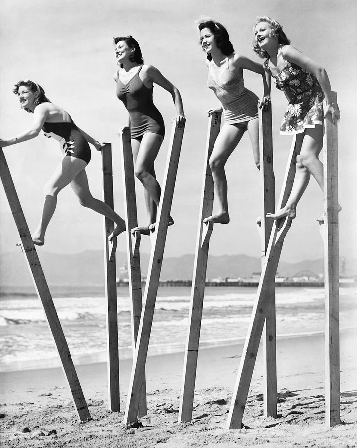 Beach Photograph - Stilt Walking On The Beach by Underwood Archives