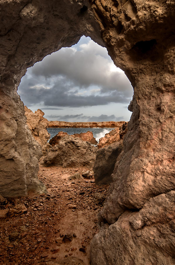 Architecture Photograph - A natural stone arch in north coast of Minorca appears like a pass to One Thousand and One Night  by Pedro Cardona Llambias