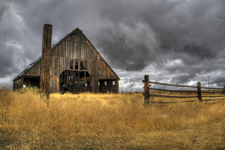 Storm over Abandoned Barn Photograph by Jean Noren