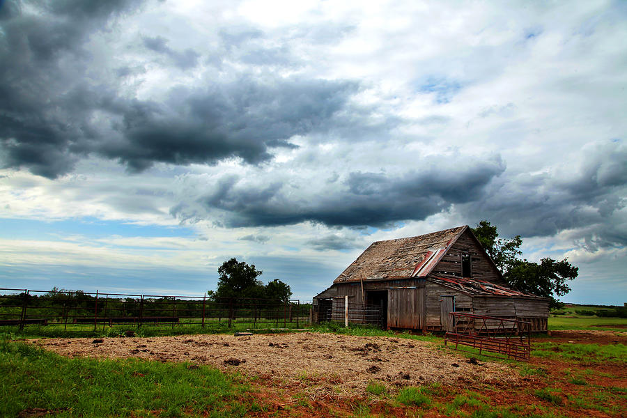 Storms loom over Barn on the Prairie Photograph by Toni Hopper