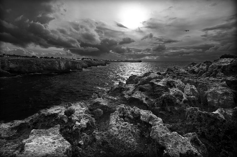 Blank and white stormy mediterranean sunrise in contrast with black rocks and cliffs in Menorca  Photograph by Pedro Cardona Llambias