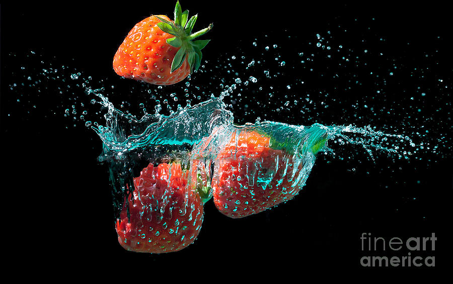 Strawberries splashed into water Photograph by Simon Bratt