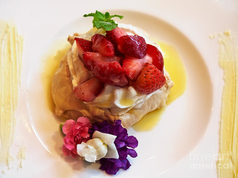 Strawberry and white chocolate Pavlova with edible flowers Photograph by Louise Heusinkveld