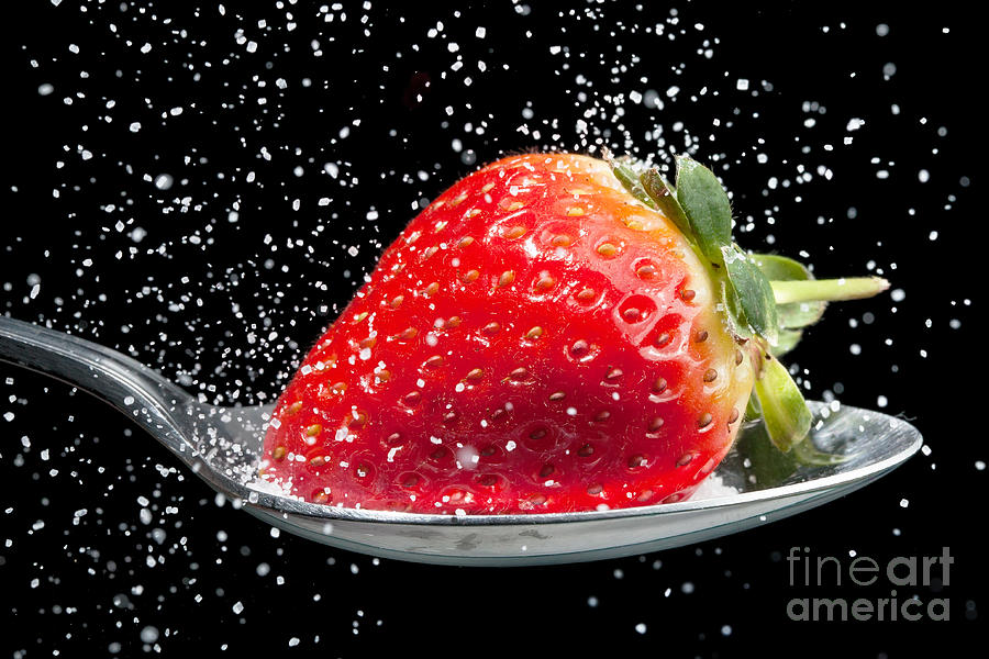 Strawberry sprinkled with sugar close up Photograph by Simon Bratt
