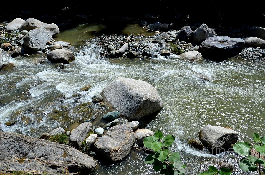 Stream water foams and rushes past boulders Photograph by Imran Ahmed