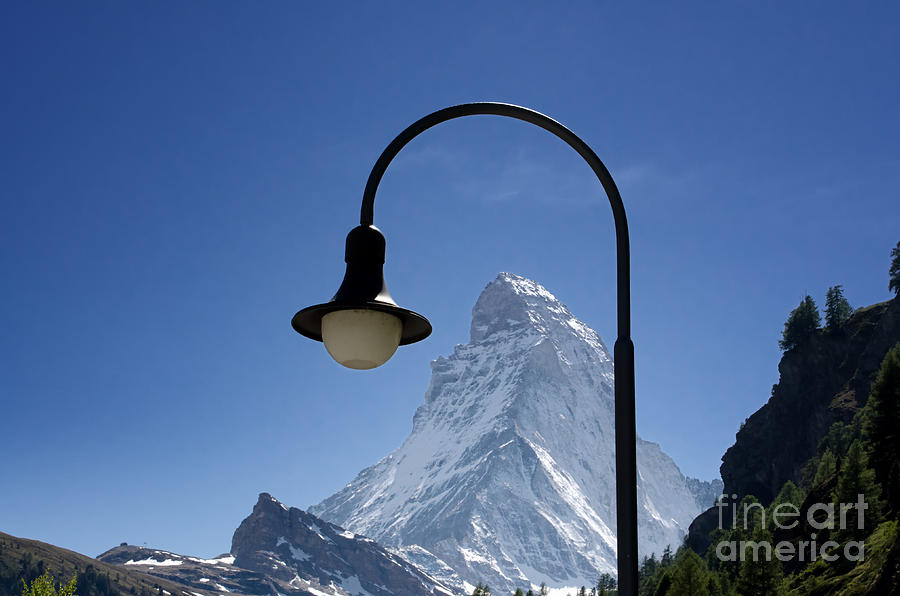 Street lamp and mountain Photograph by Mats Silvan