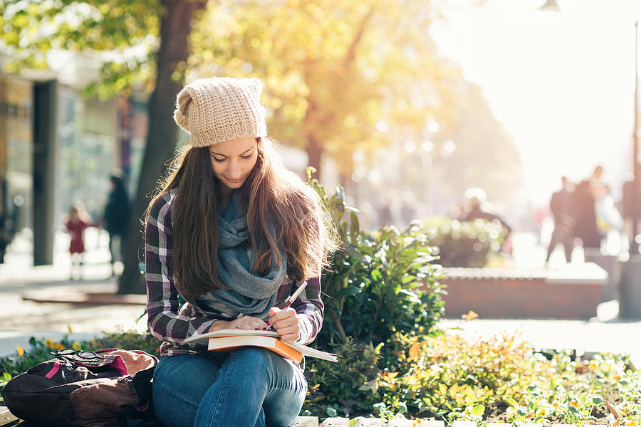 Student girl studying in the campus. Photograph by Mixmike