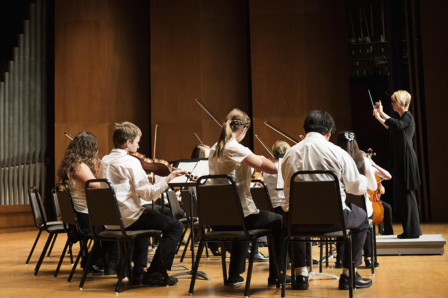 Student orchestra playing on stage Photograph by Hill Street Studios