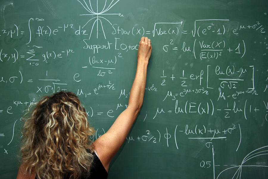 Student Solves Mathematics Problem On Blackboard Photograph by Virtualphoto
