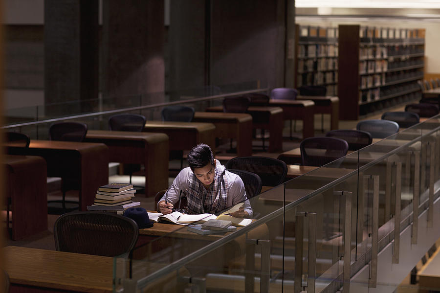 Student working in library at night Photograph by Sam Edwards