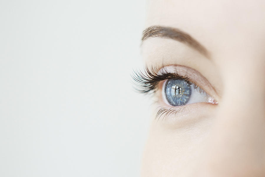 Studio close up of mid adult womans gazing blue eye Photograph by Liam Norris