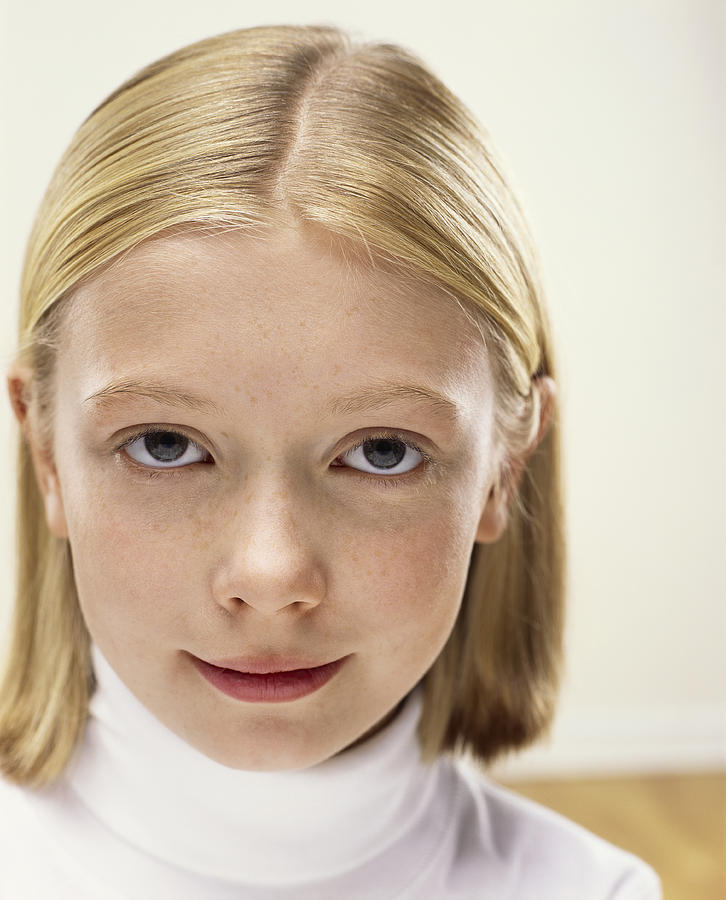 Studio Portrait of a Young Girl Wearing a White Polo-Neck Jumper Photograph by Digital Vision.