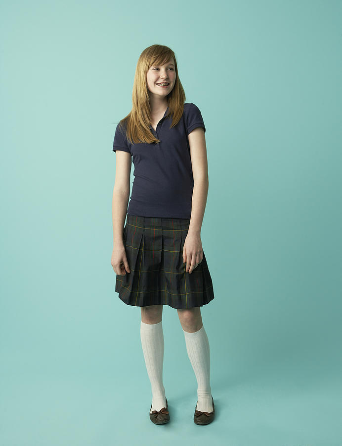 Studio shot of schoolgirl (12-13) smiling Photograph by Andy Ryan