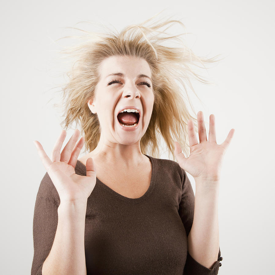 Studio shot of young woman screaming Photograph by Jessica Peterson