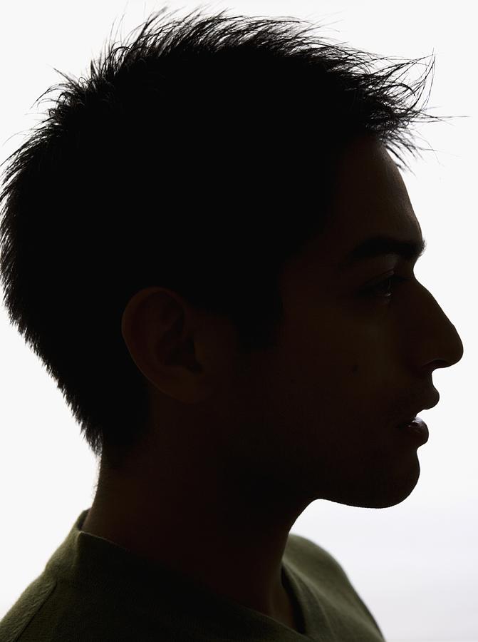 Studio shot profile silhouette of young man Photograph by Blend Images - Tanya Constantine